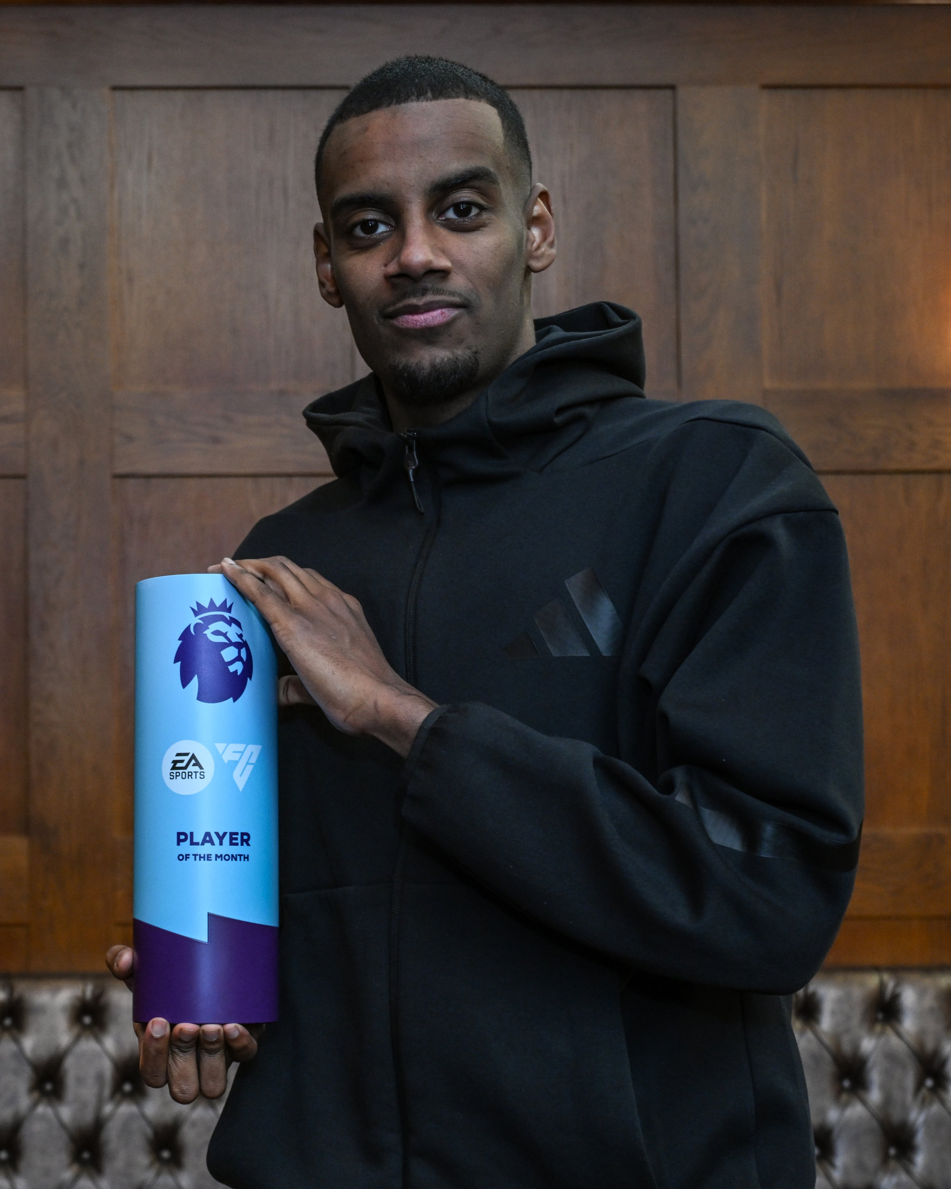 Alexander Isak holding his EA Sports Premier League Player of the Month award