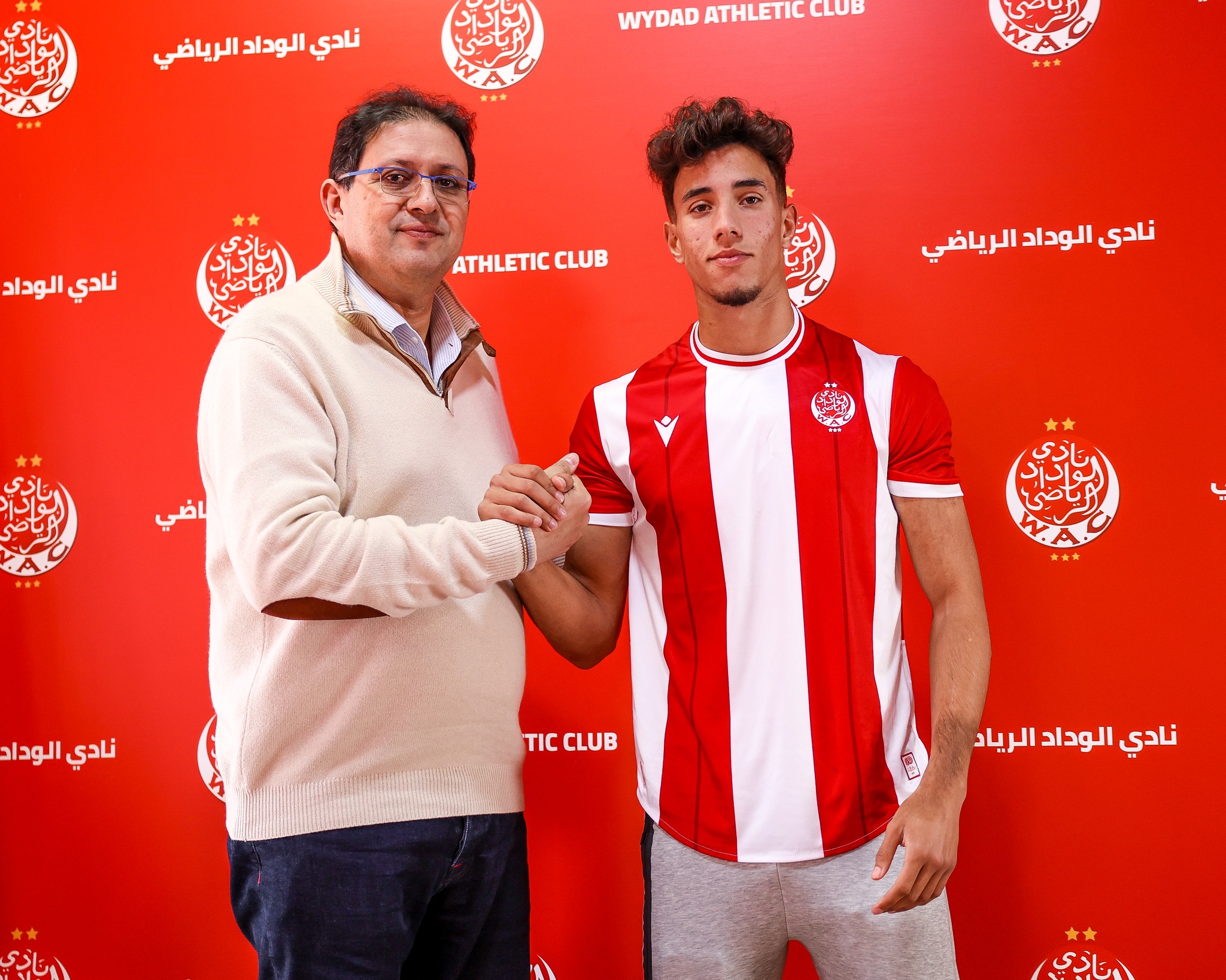 May be an image of ‎2 people, people playing football and ‎text that says '‎نادي ناديالودادالرياضي الوداد الرياضي الا CLUB ATHLETIC WYDAD نادي الوداد ATHLETIC CLUB ATHLETICCLUB نادي الوداد الرياضي ياضي الياة نادي نادي الوداد االياّهم CLUB TICCLUB τι نادي الوداد الرياد اتادي اادي‎'‎‎